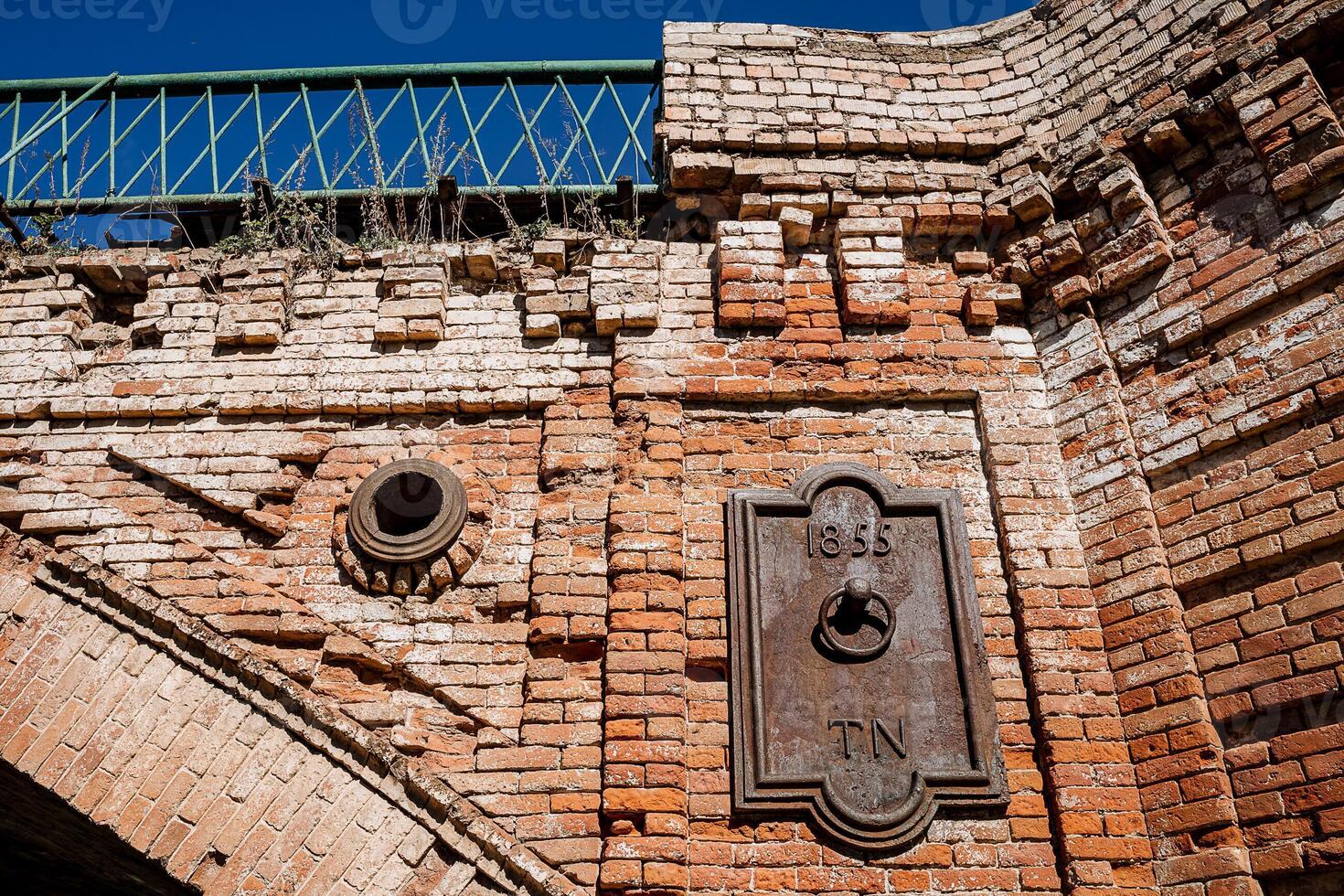 Ancient stone bridge over the river. Brick construction of the bridge. Arch construction for crossing the water. photo