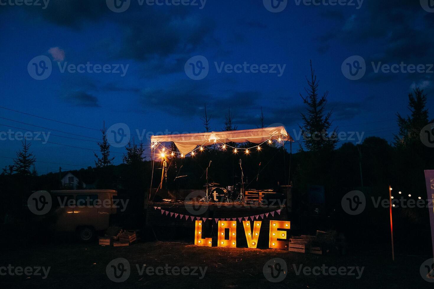 Big letters love with light bulbs. Festive decoration of a celebration in nature. The word love glows in the dark. photo
