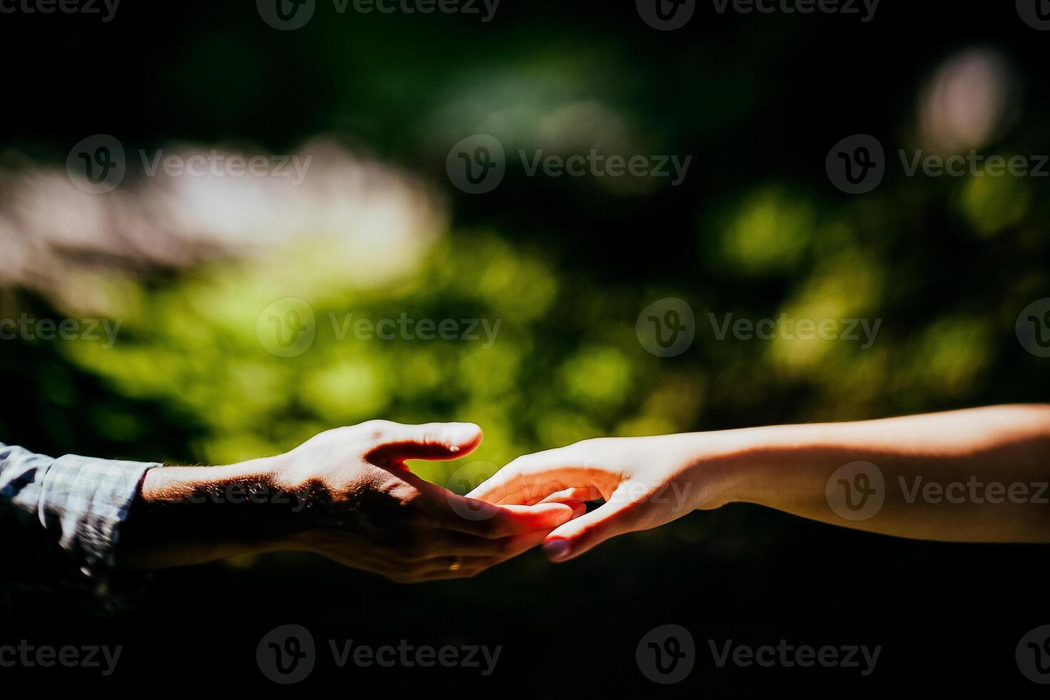 Close-up of a woman and a man holding out their hands, two people holding hands. The symbol is a sign of sincere feelings, a loved one. the concept of true friendship, outdoors photo