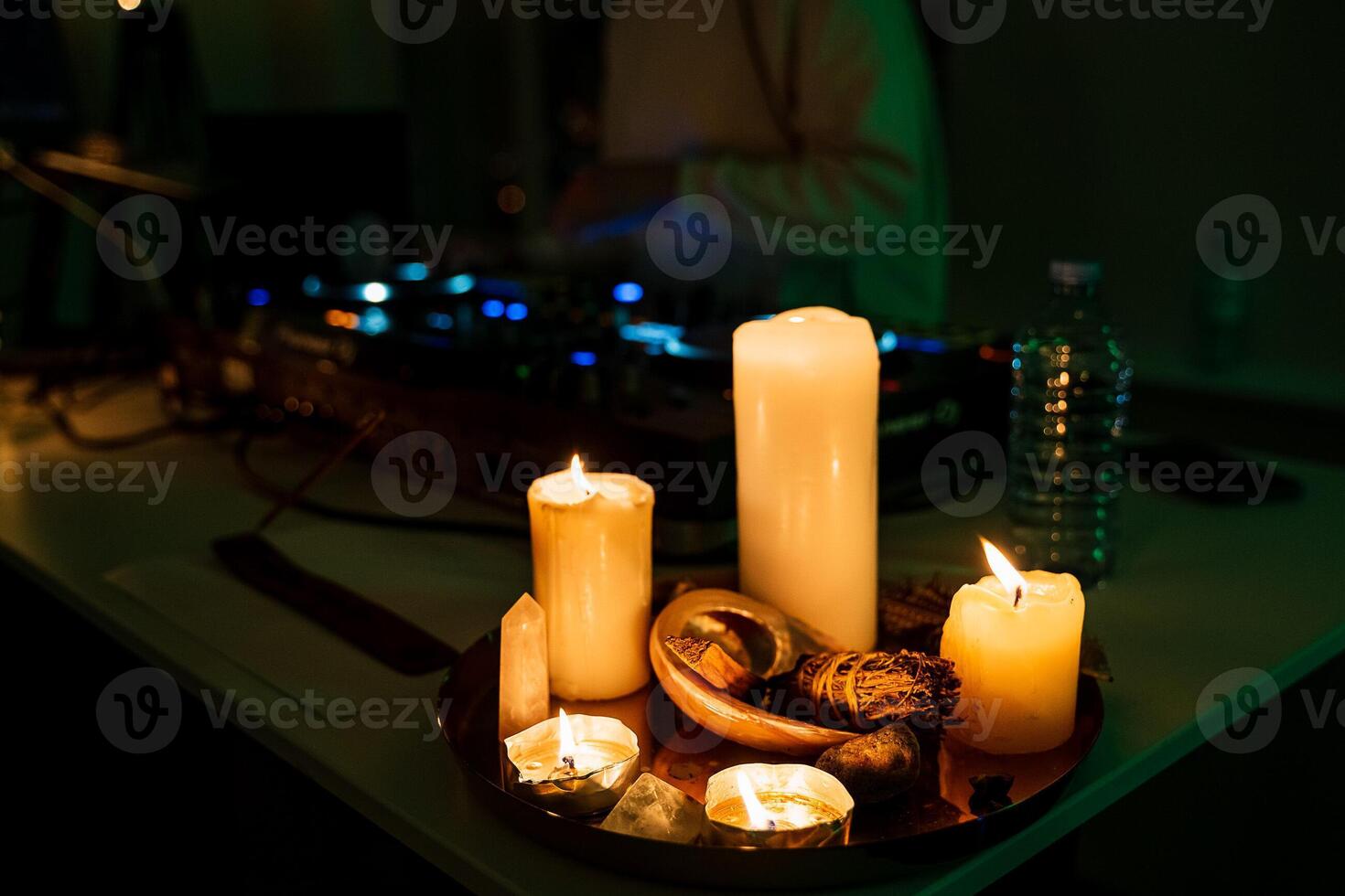 A table with candles and a dj photo