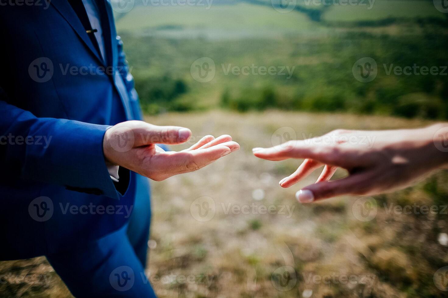 Close-up of a woman and a man holding out their hands, two people holding hands. The symbol is a sign of sincere feelings, a loved one. the concept of true friendship, outdoors photo