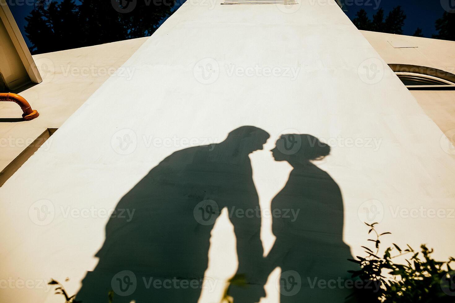silhouette of a man and a woman, outdoors, shadows from people photo