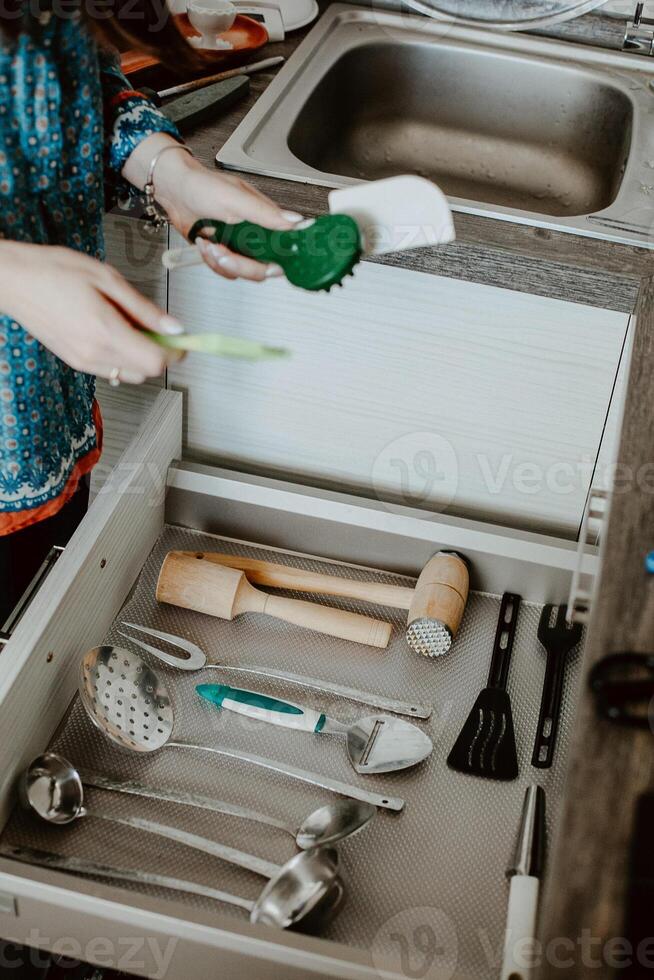 A set of Cutlery in a drawer. Correct placement of knives, forks and spoons in the drawer. Order in the kitchen. The concept of order in the house. photo