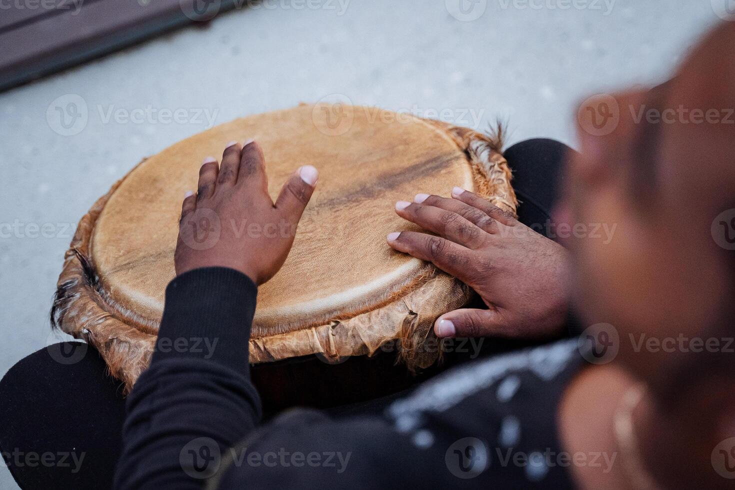 play with your hands on the drum, an African-American plays the djembe drum, top view, close-up photo