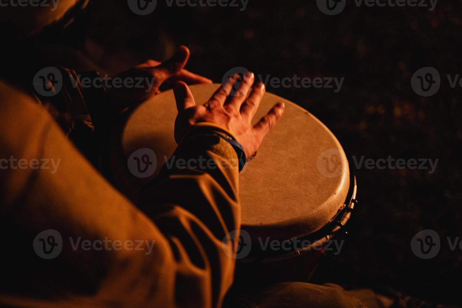play with your hands on the drum, an African-American plays the djembe drum, top view, close-up photo