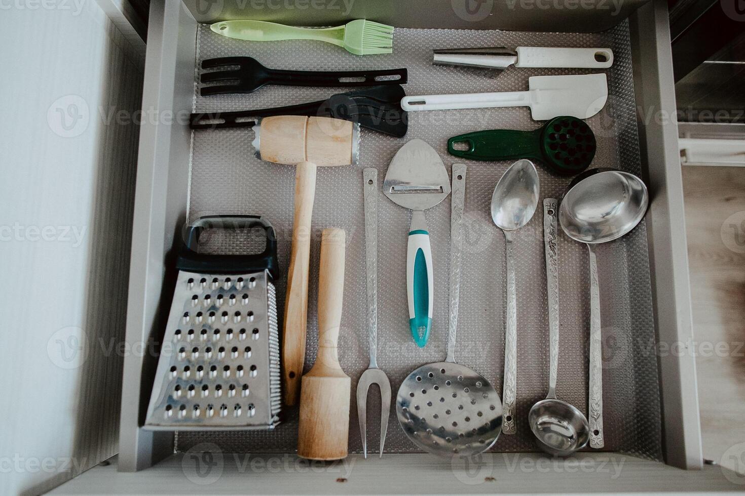 A set of Cutlery in a drawer. Correct placement of knives, forks and spoons in the drawer. Order in the kitchen. The concept of order in the house. photo