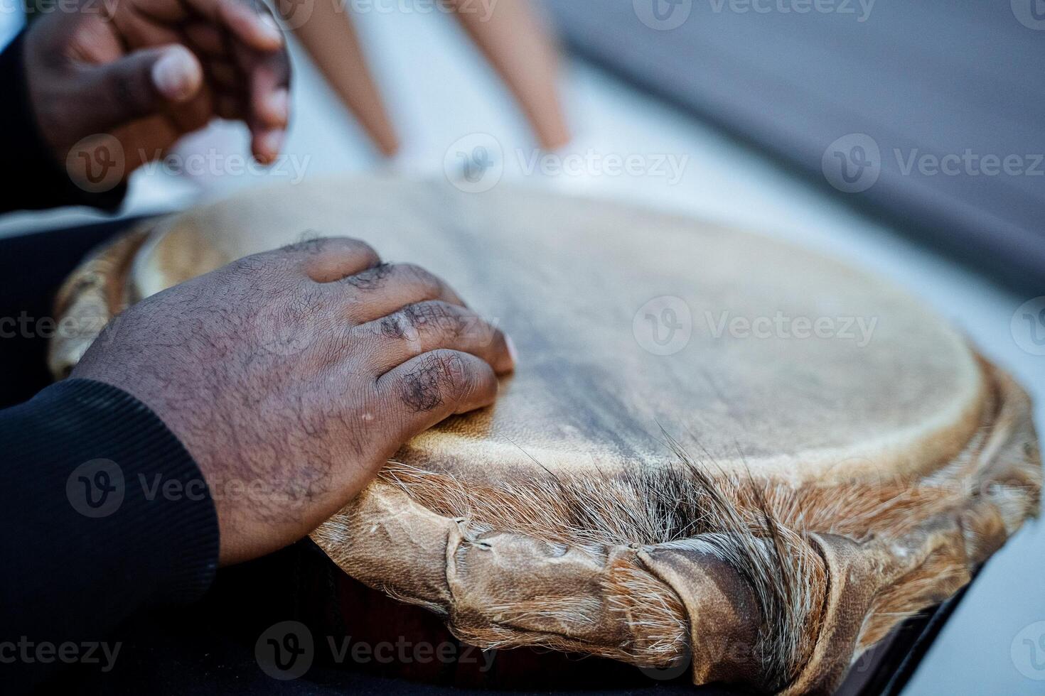 play with your hands on the drum, an African-American plays the djembe drum, top view, close-up photo