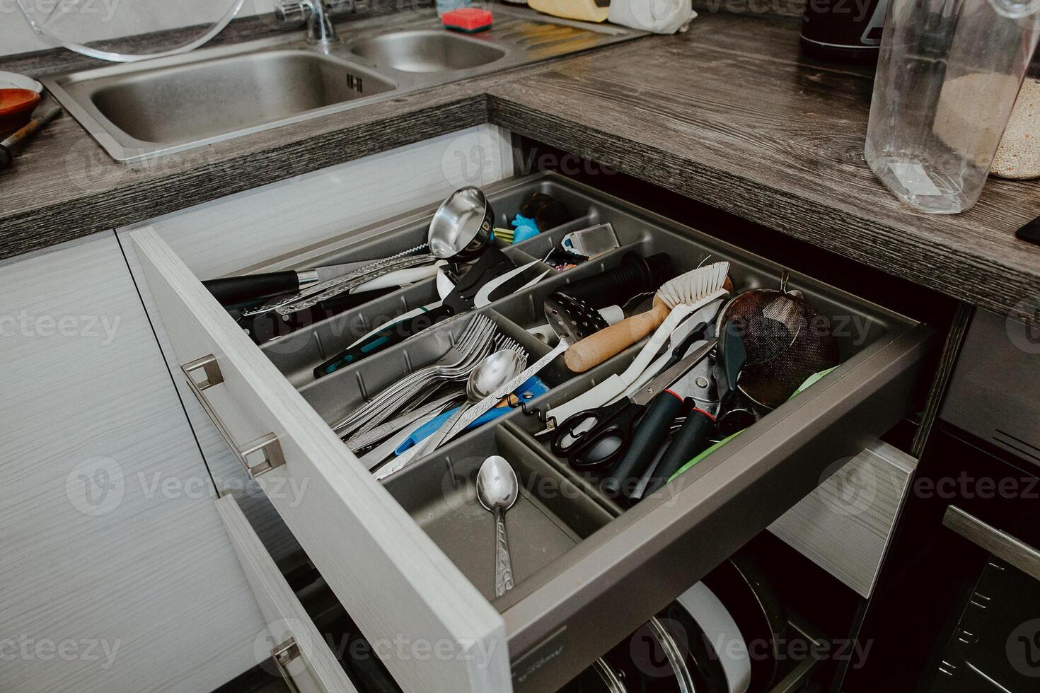 A set of Cutlery in a drawer. Correct placement of knives, forks and spoons in the drawer. Order in the kitchen. The concept of order in the house. photo
