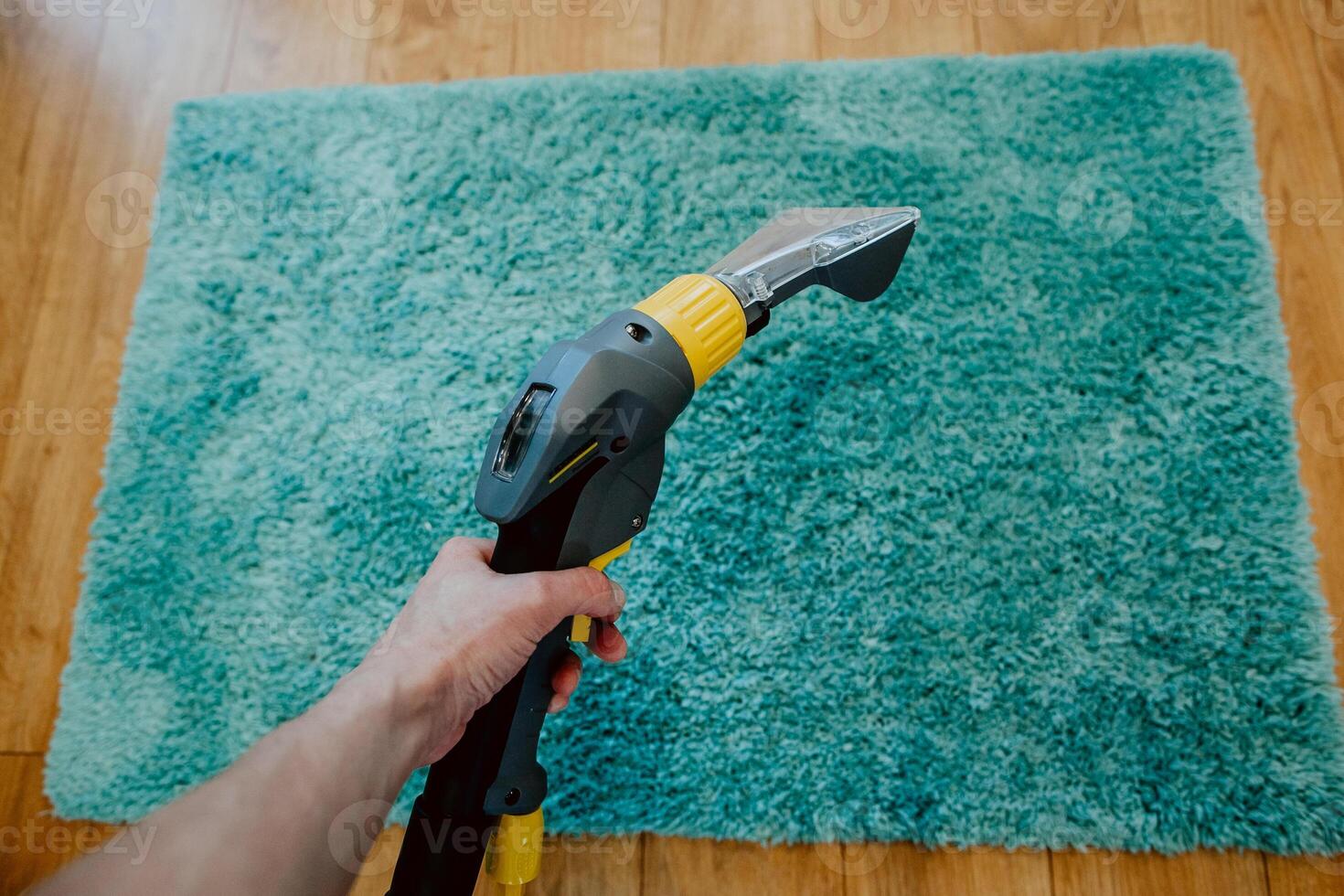 carpet cleaning, vacuum cleaner tube in women's hands cleans the carpet, the concept of cleanliness in the house, apartment cleaning, textile cleaning machine, order photo