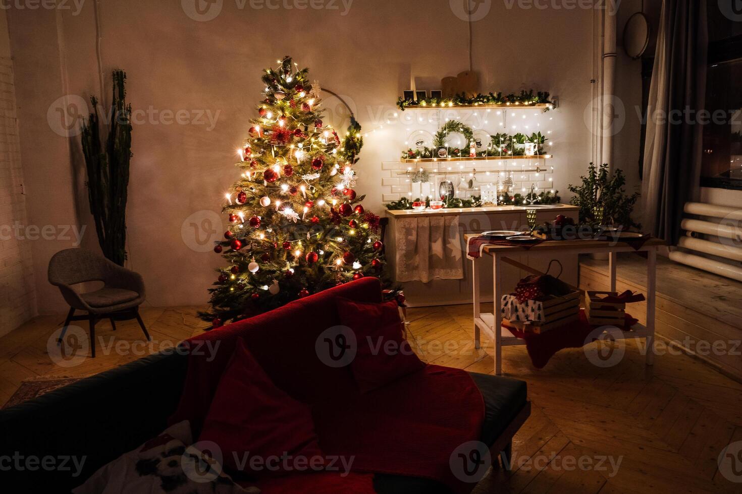 A room with a christmas tree and a couch photo