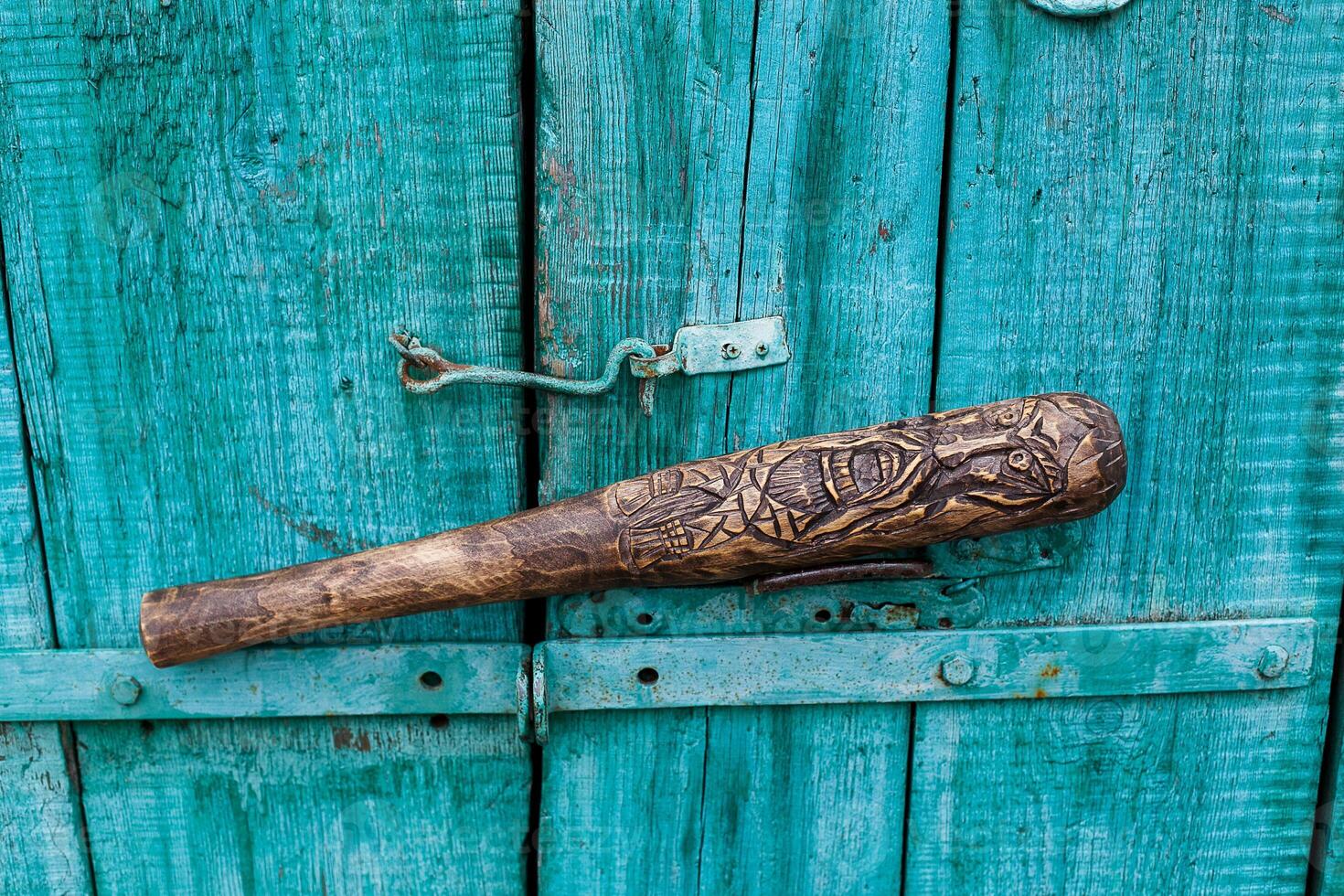 handmade wooden baseball bat, wood carving, skull image, skeleton drawing photo