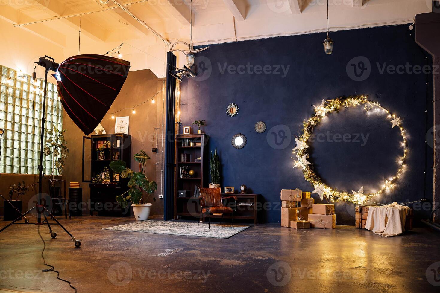 A photo studio with a large blue wall and lights