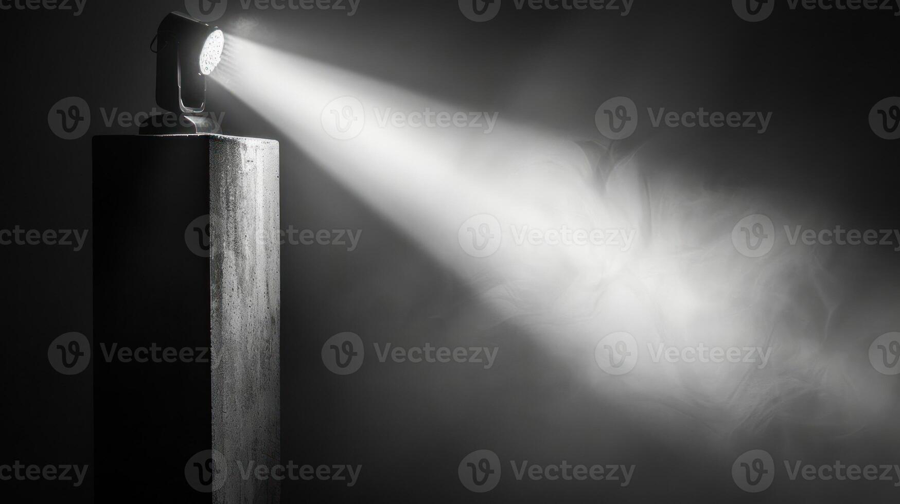 A spotlight shines through smoke and fog on a wooden platform. photo