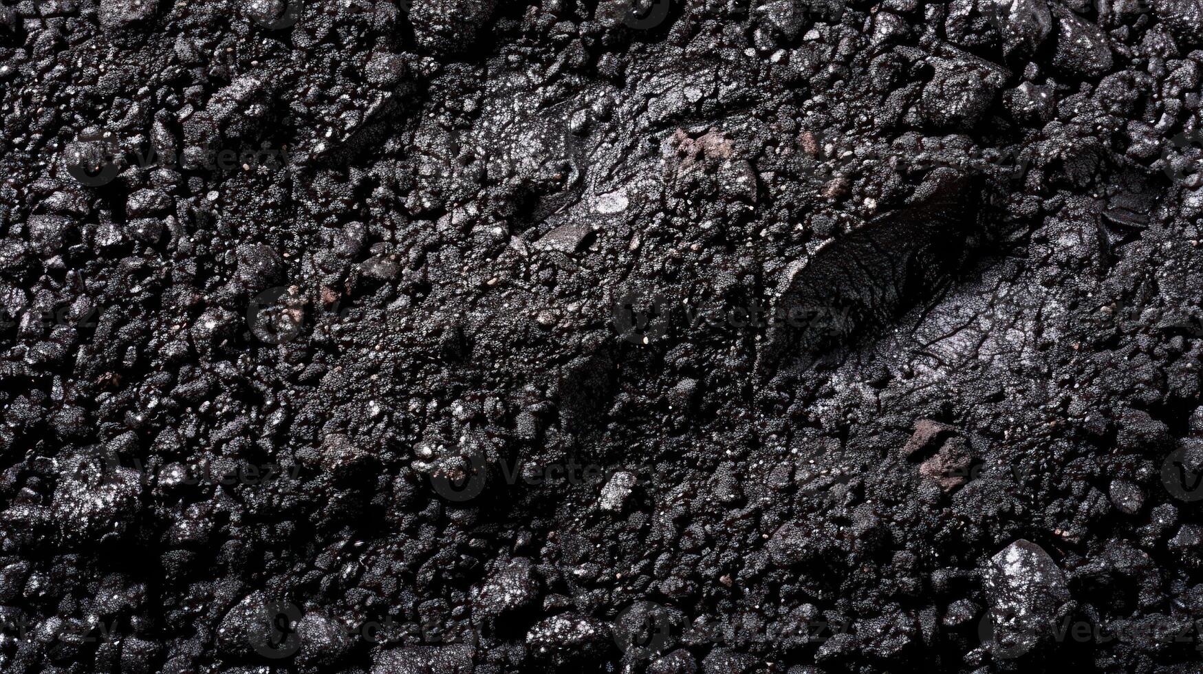 Close-up of black charcoal, a natural material with a rough texture. photo