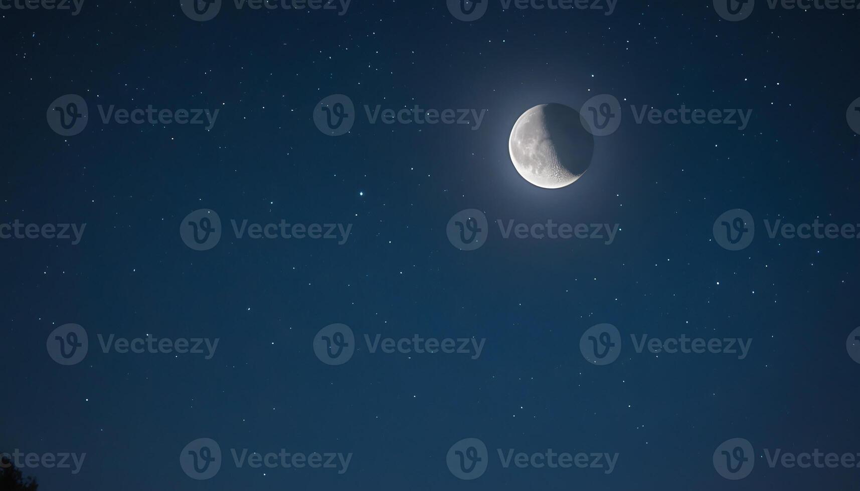 A moon is seen in the night sky photo
