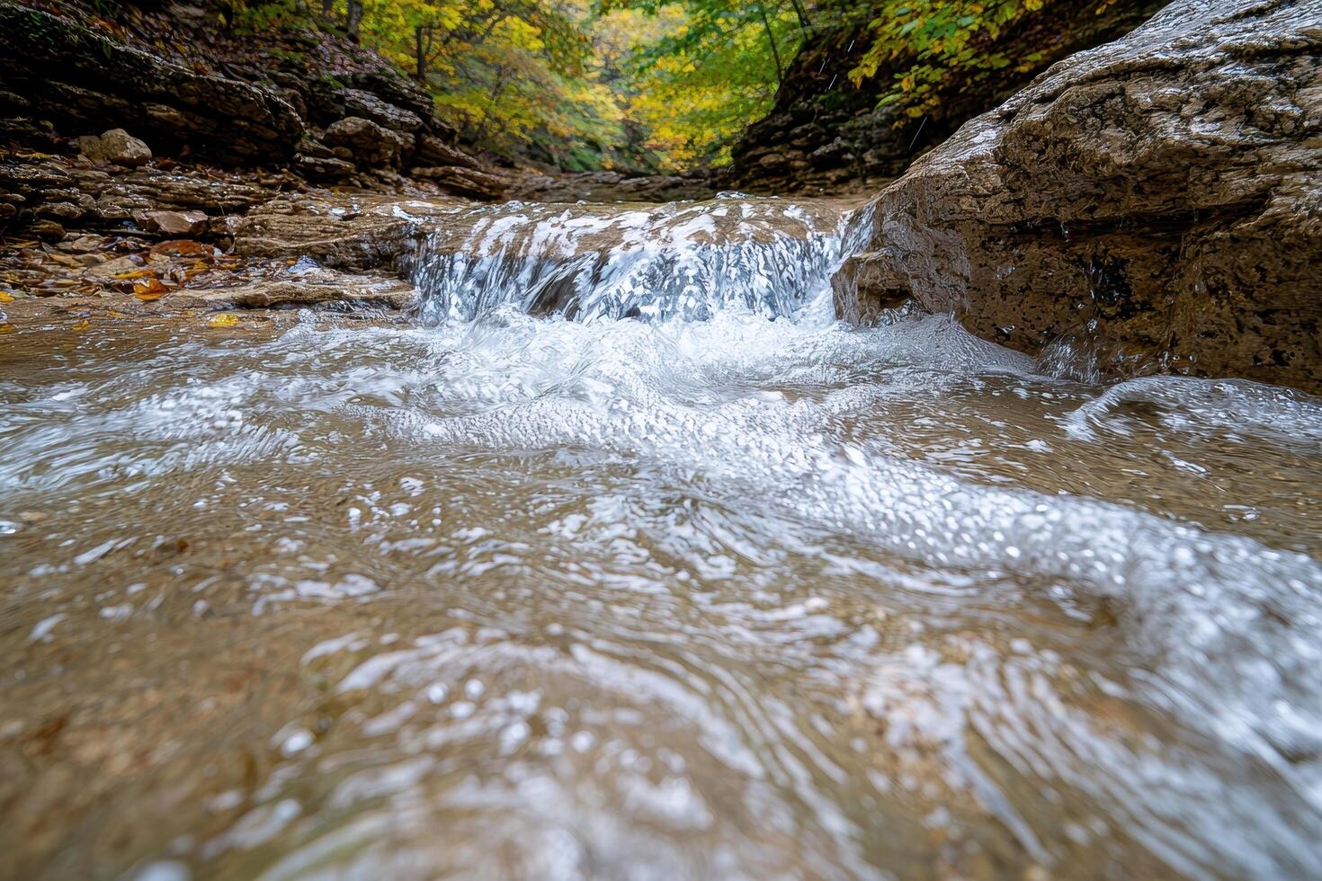 Cascading waterfall in autumn forest photo