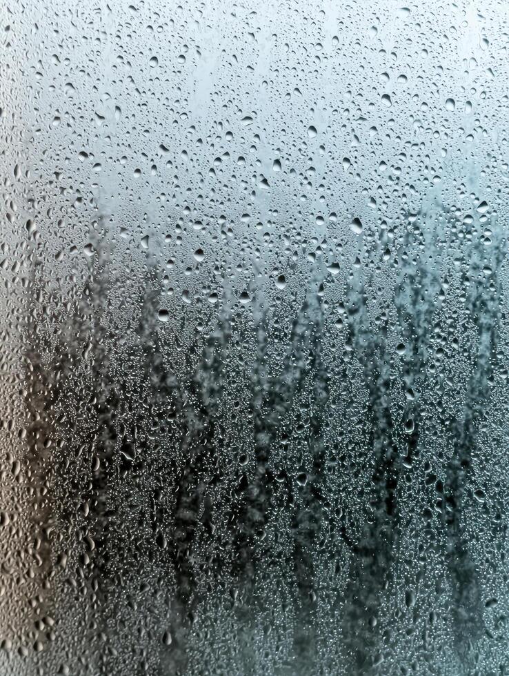 Rainy day window with water droplets photo