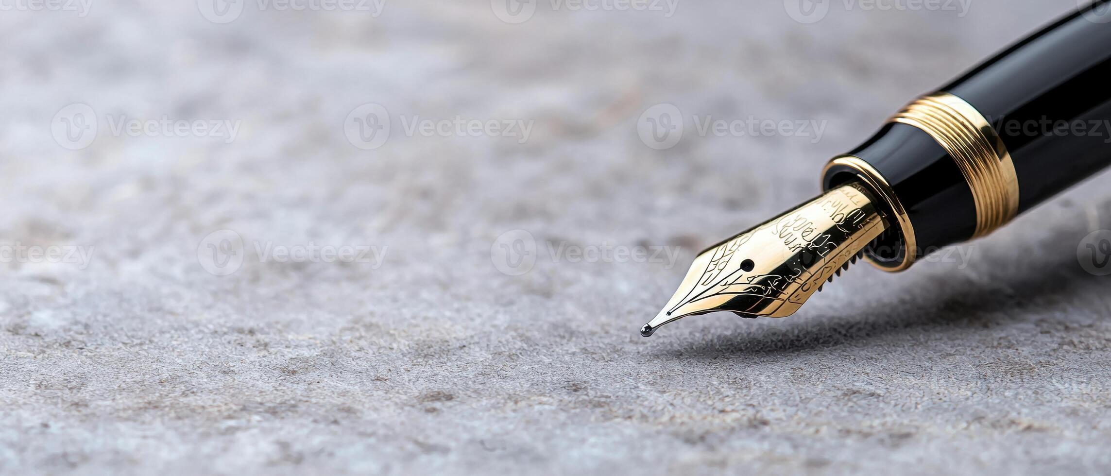 close up of a fountain pen nib on a textured surface photo