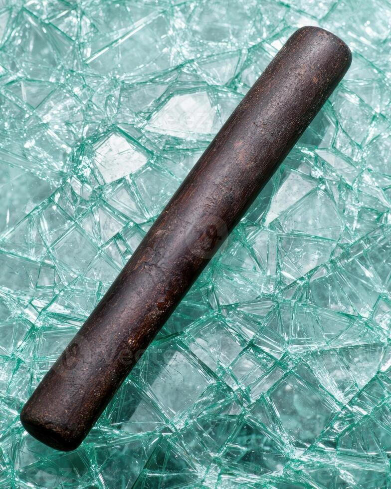 Wooden baseball bat on shattered glass background photo