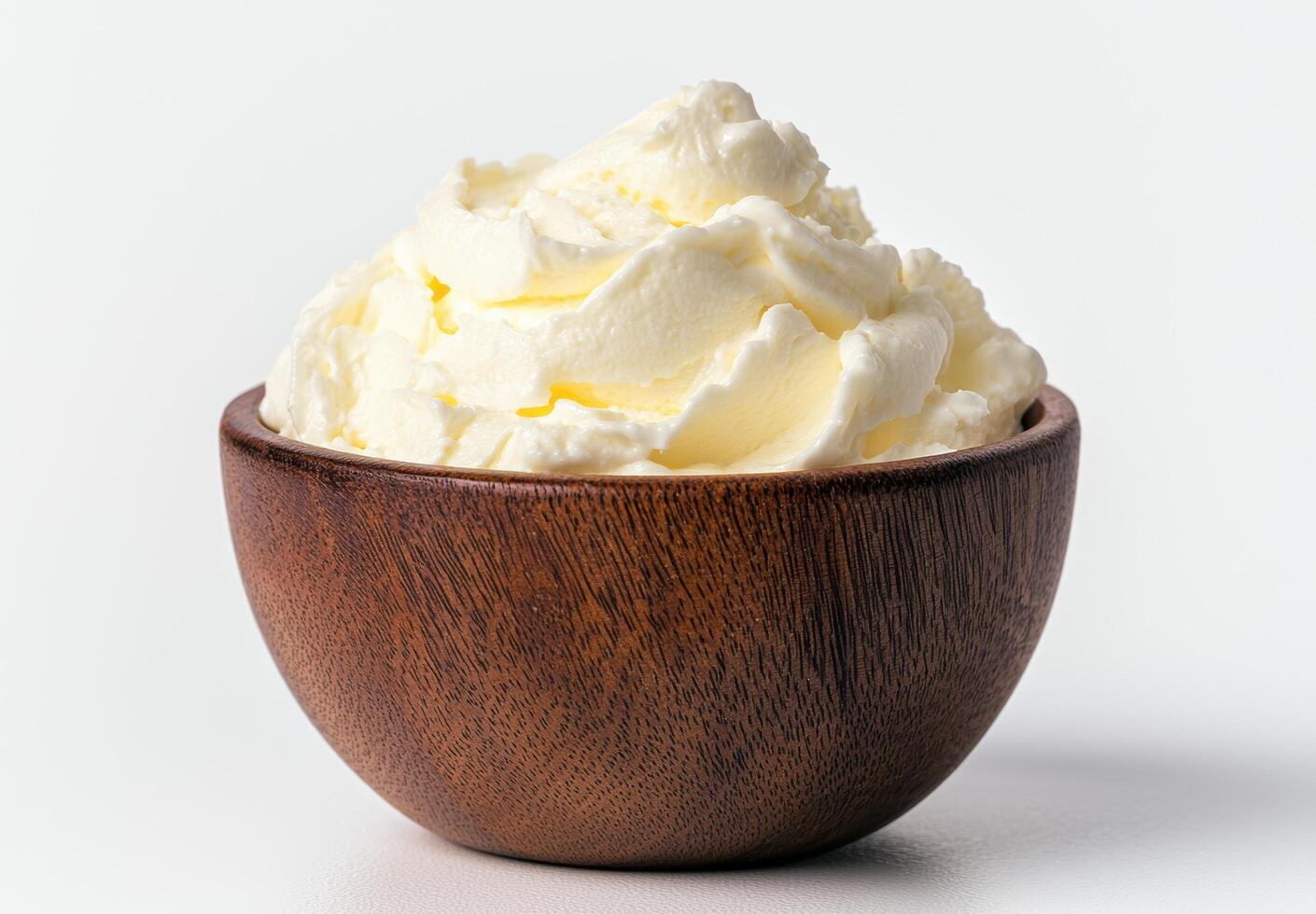 Creamy whipped cream in a wooden bowl photo