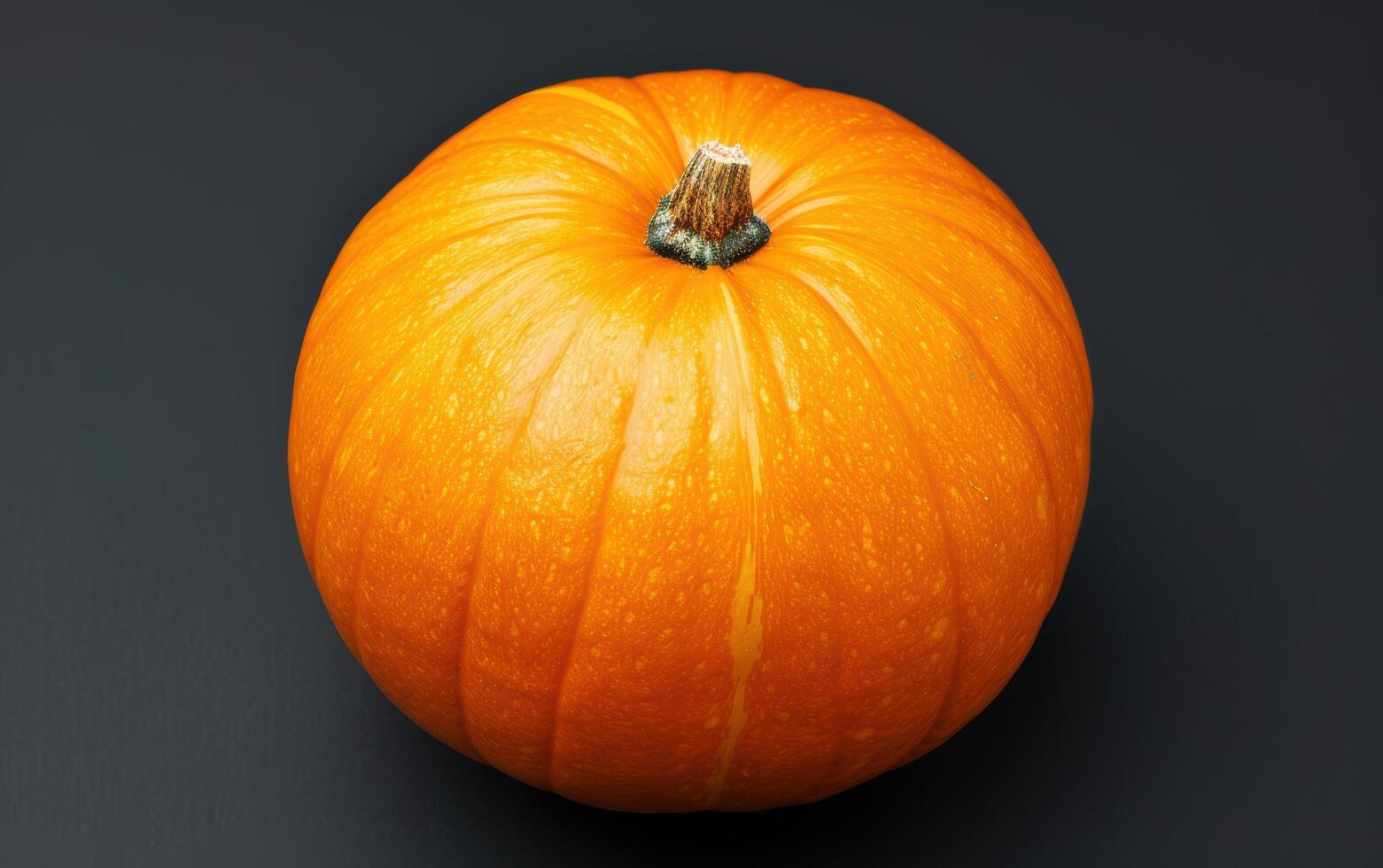 Vibrant orange pumpkin on dark background photo
