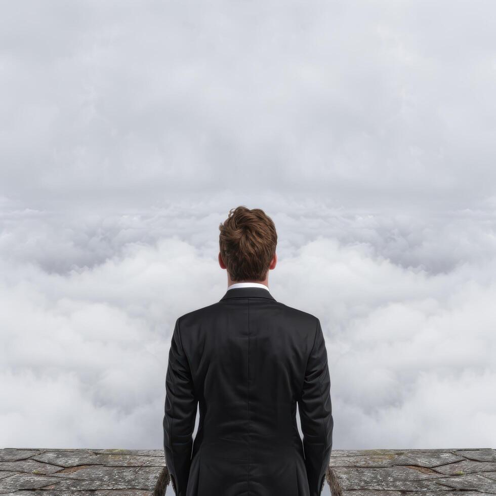 businessman looking out over clouds photo