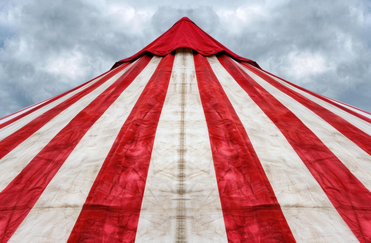 Dramatic circus tent against cloudy sky photo