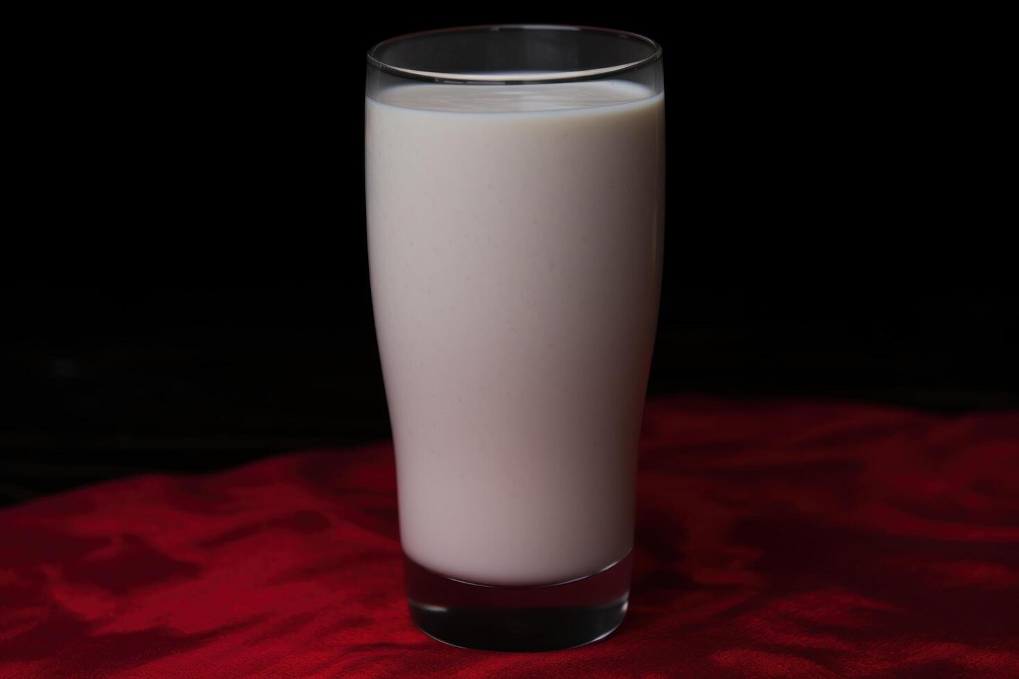glass of creamy milk on red cloth photo