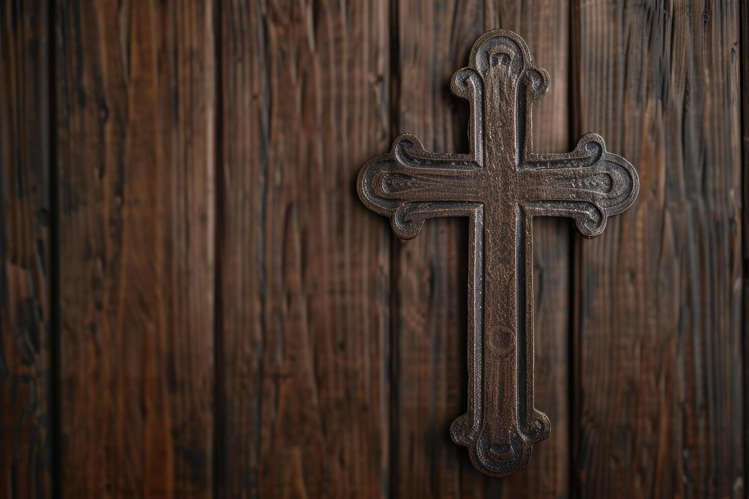 Ornate wooden cross on rustic background photo