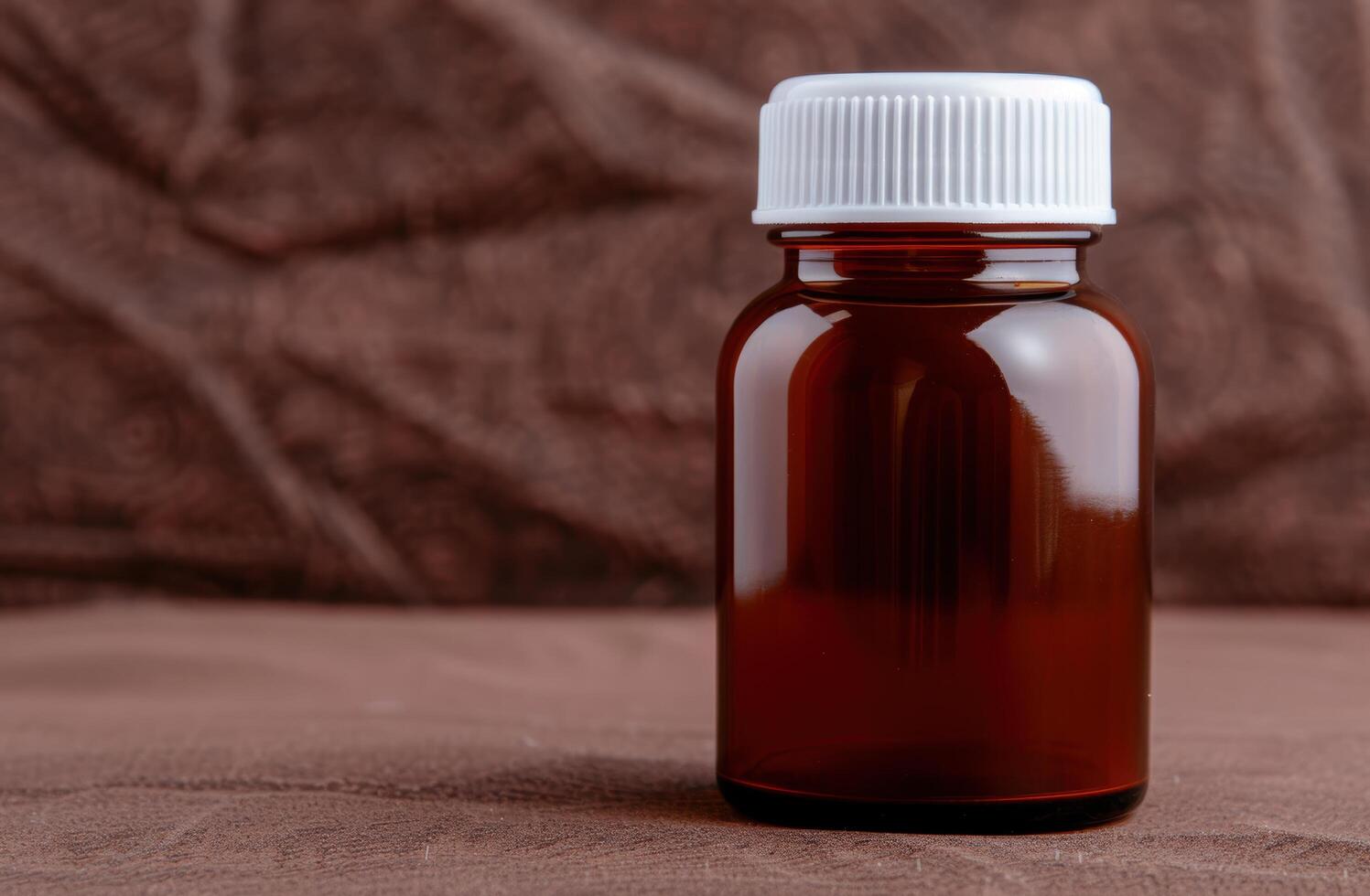 Amber glass bottle with white cap on wooden surface photo