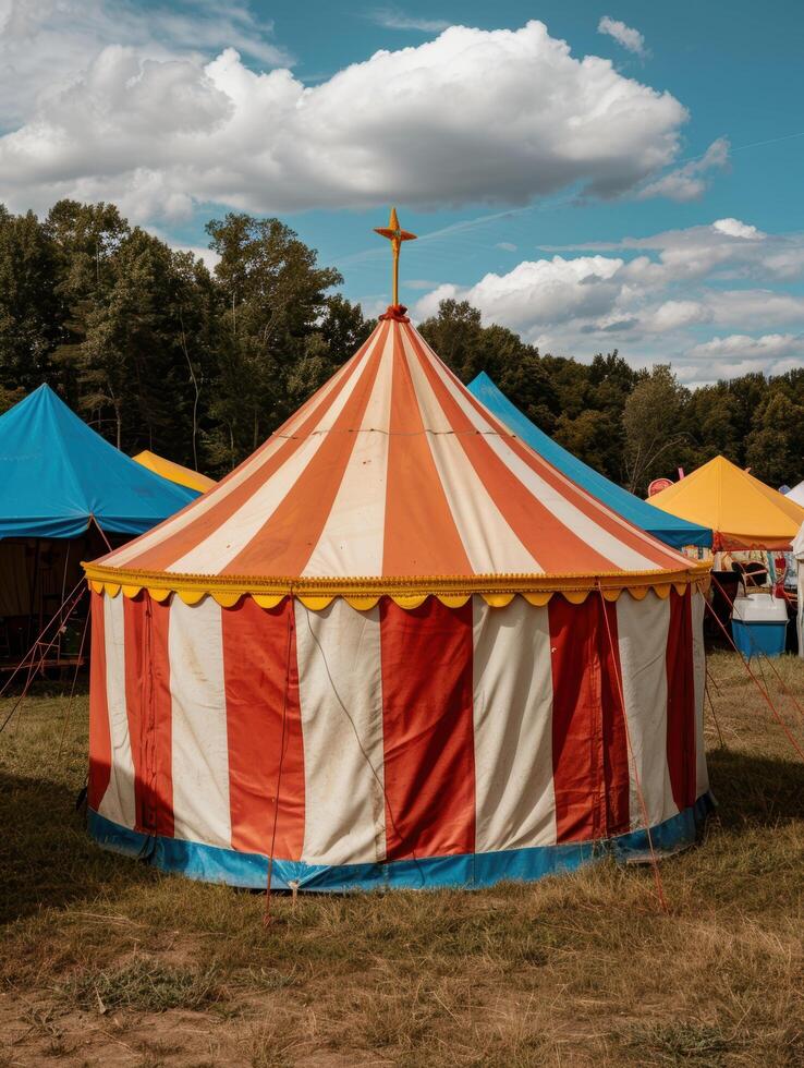 Colorful circus tent in a grassy field photo