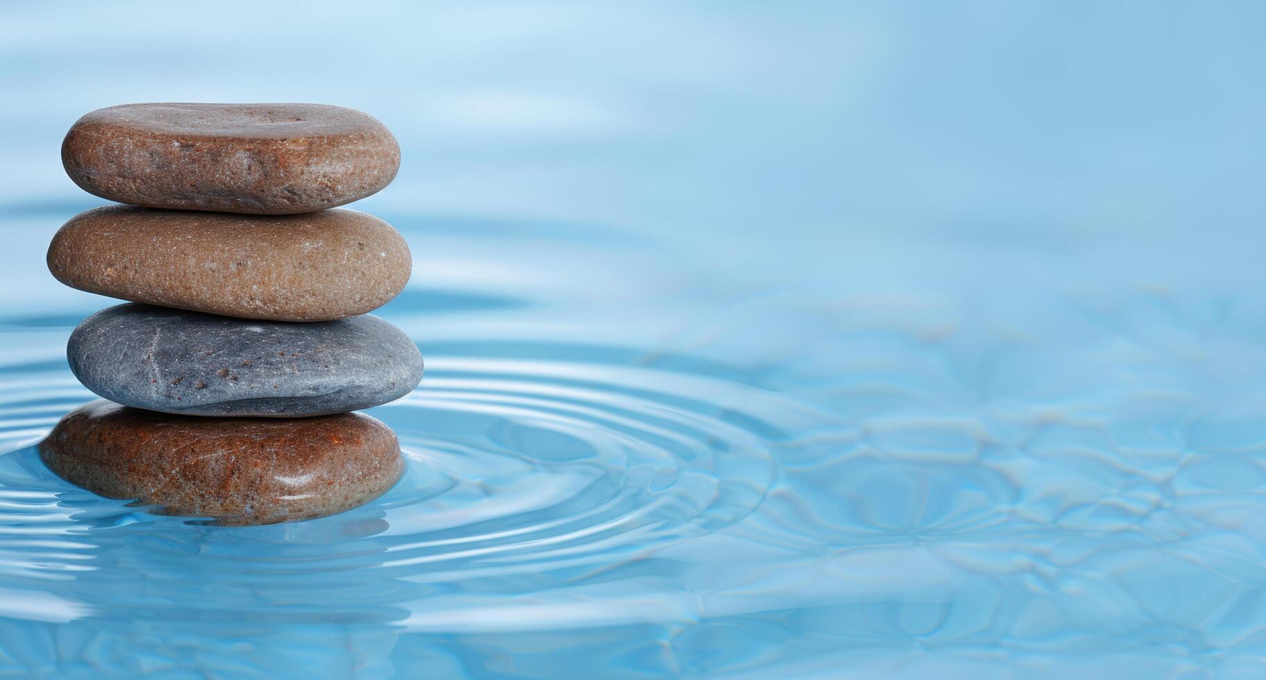 Balanced zen stones in tranquil water photo