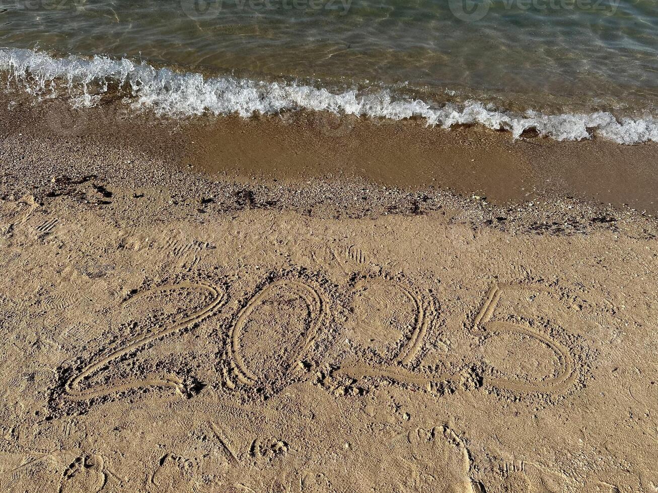 Year 2025 Written in Sand. Christmas photo