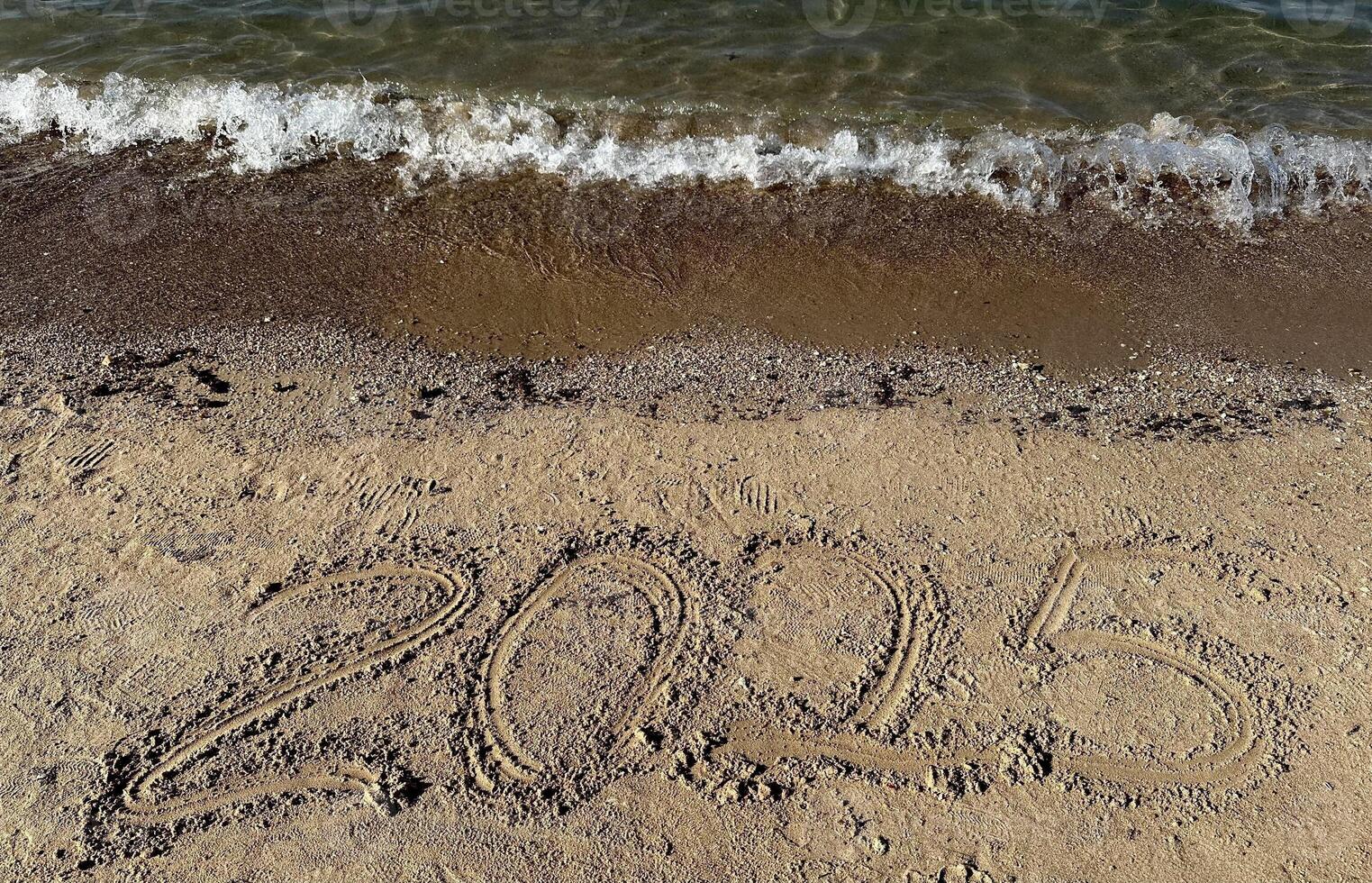 Year 2025 Written in Sand. Christmas photo