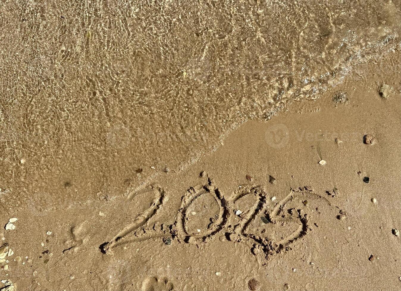 Year 2025 Written in Sand. Christmas photo