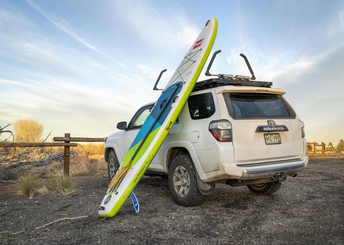 Fort Collins, CO, USA - February 17, 2023 - Toyota 4Runner SUV with Voyager, an inflatable touring stand up paddleboard by Red after winter paddling in one of Fort Collins natural areas. photo