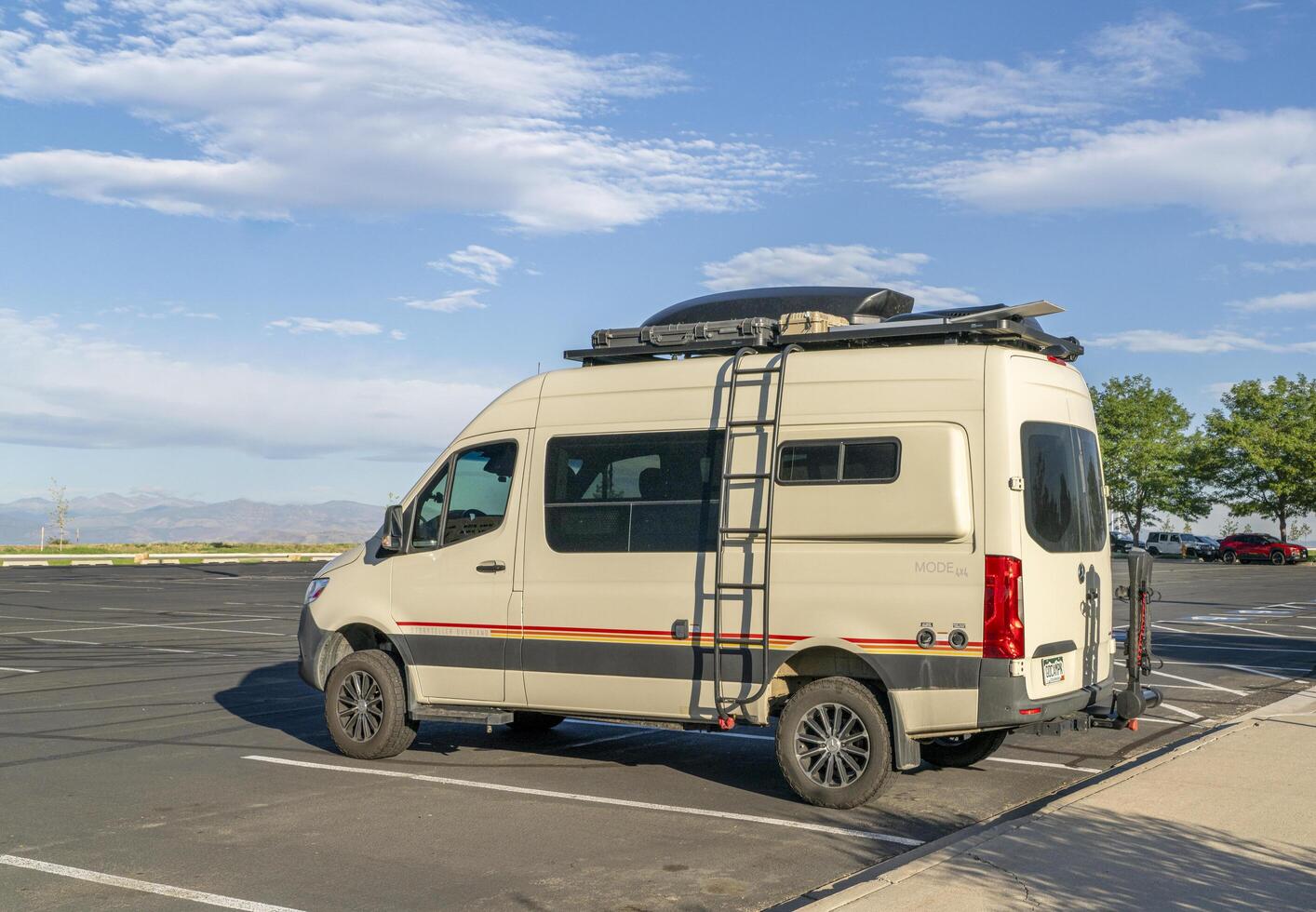 Loveland, CO, USA - August 24, 2024 - Storyteller Overland Mode, 4x4 camper van on Mercedes Sprinter chassis on a parking lot in Colorado foothills. photo