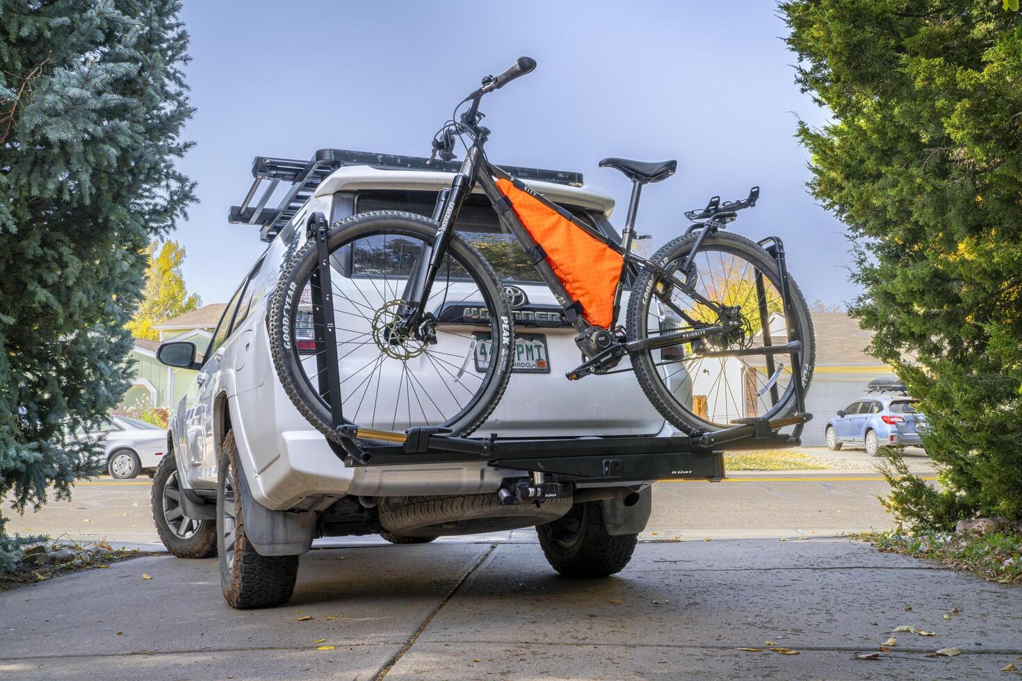 Fort Collins, CO, USA - October 25, 2024 - 600x Priority adventure mountain bike on the back of Toyota 4Runner SUV mounted with Kuat piston hitch rack. photo