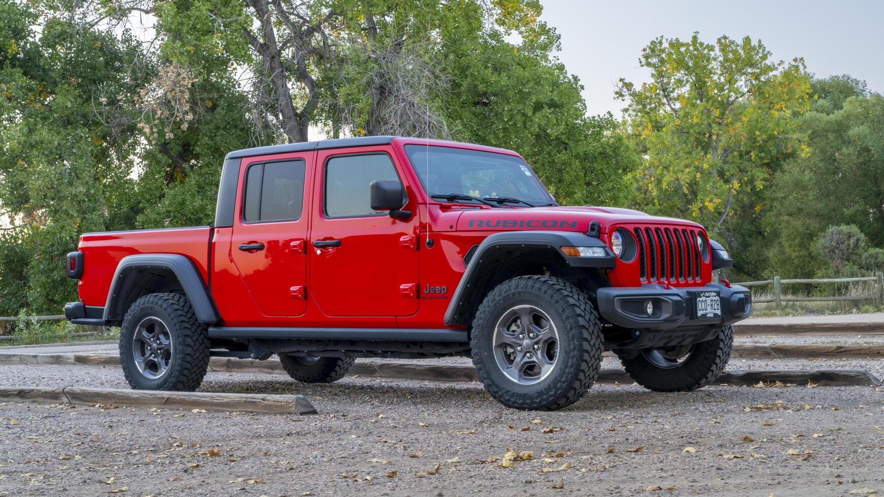 Fort Collins, CO, USA - October 2, 2024 - A new Jeep Gladiator pick up, Rubicon model at a trailhead parking. photo