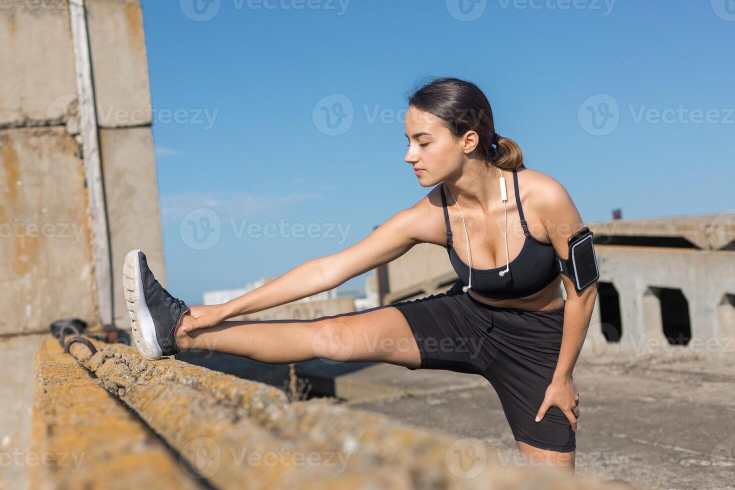 Young attractive woman doing exercise working out outdoors. photo