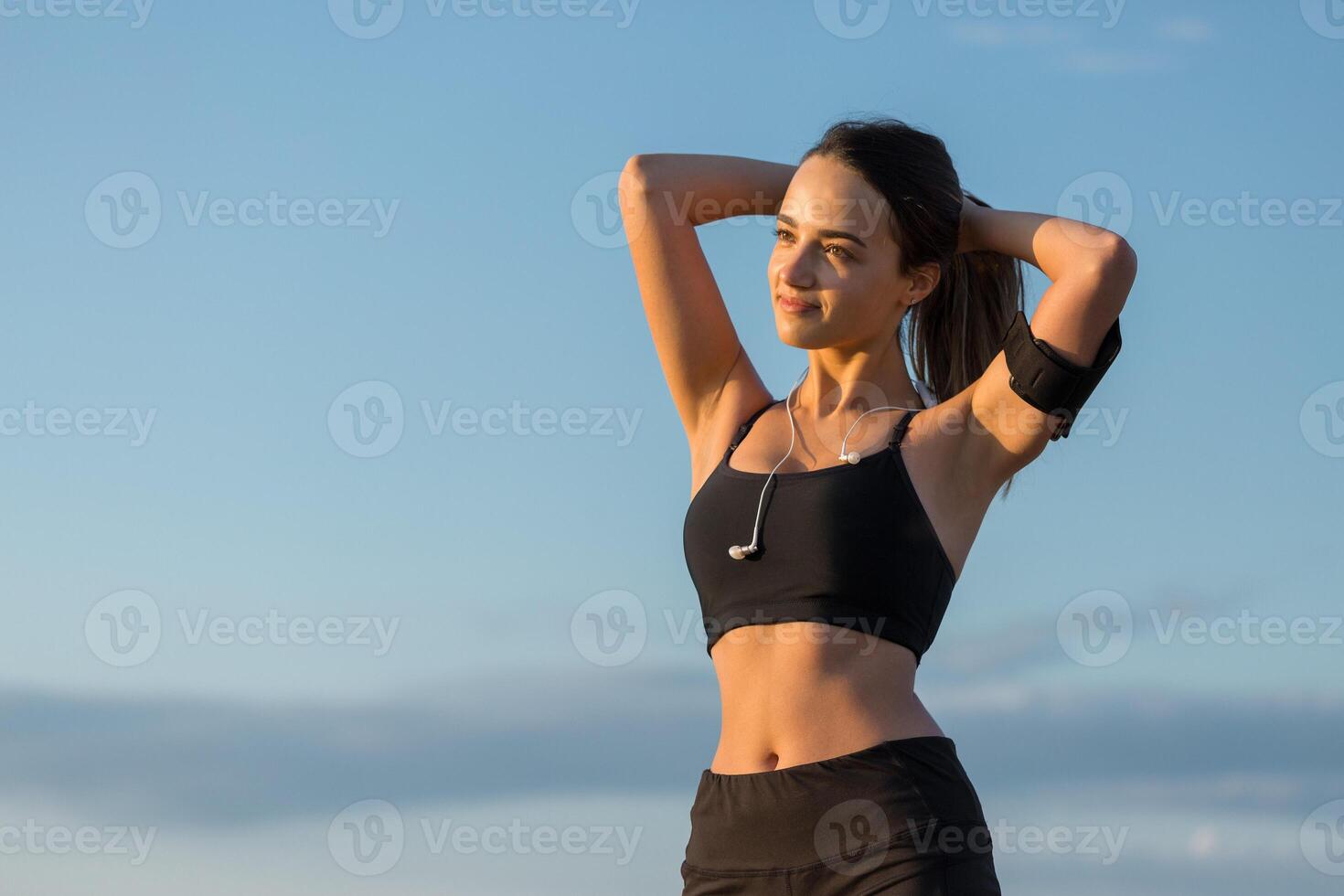 Young attractive woman doing exercise working out outdoors. photo
