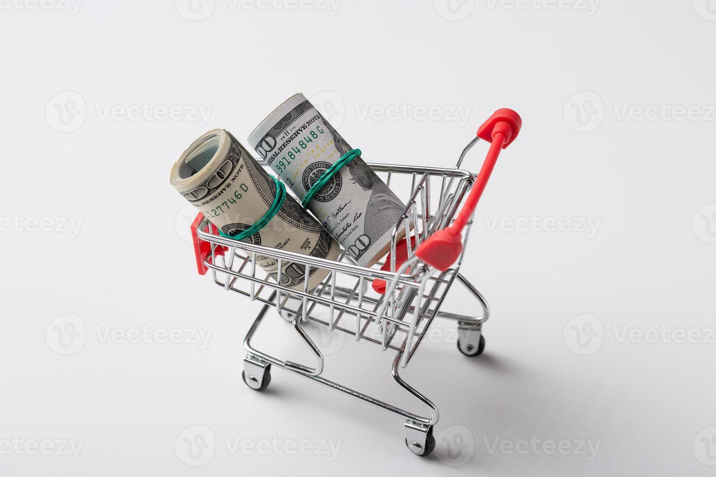 American banknotes in a metal grocery basket on a white background. photo