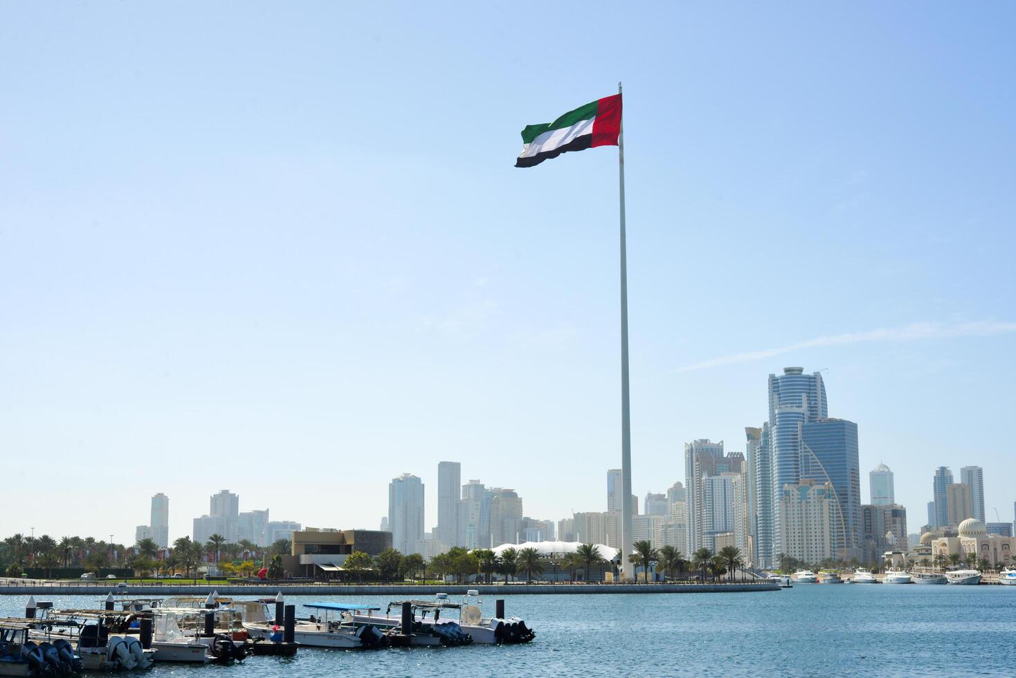 SHARJAH, UAE - February 14, 2023 Flag of the United Arab Emirates in Sharjah on the coastline. photo