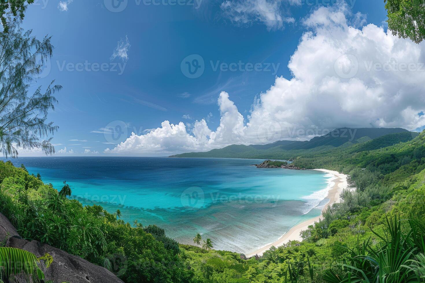 Tropical Beach with Lush Greenery and Blue Ocean Under a Cloudy Sky photo