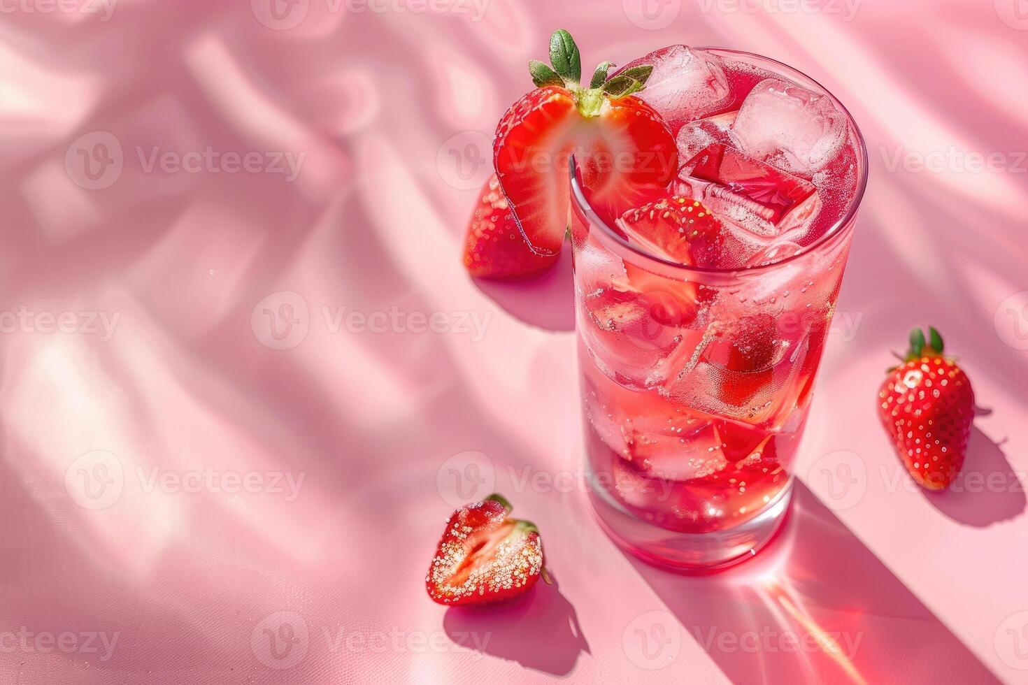 Refreshing Strawberry Drink with Ice Cubes on Pink Background photo
