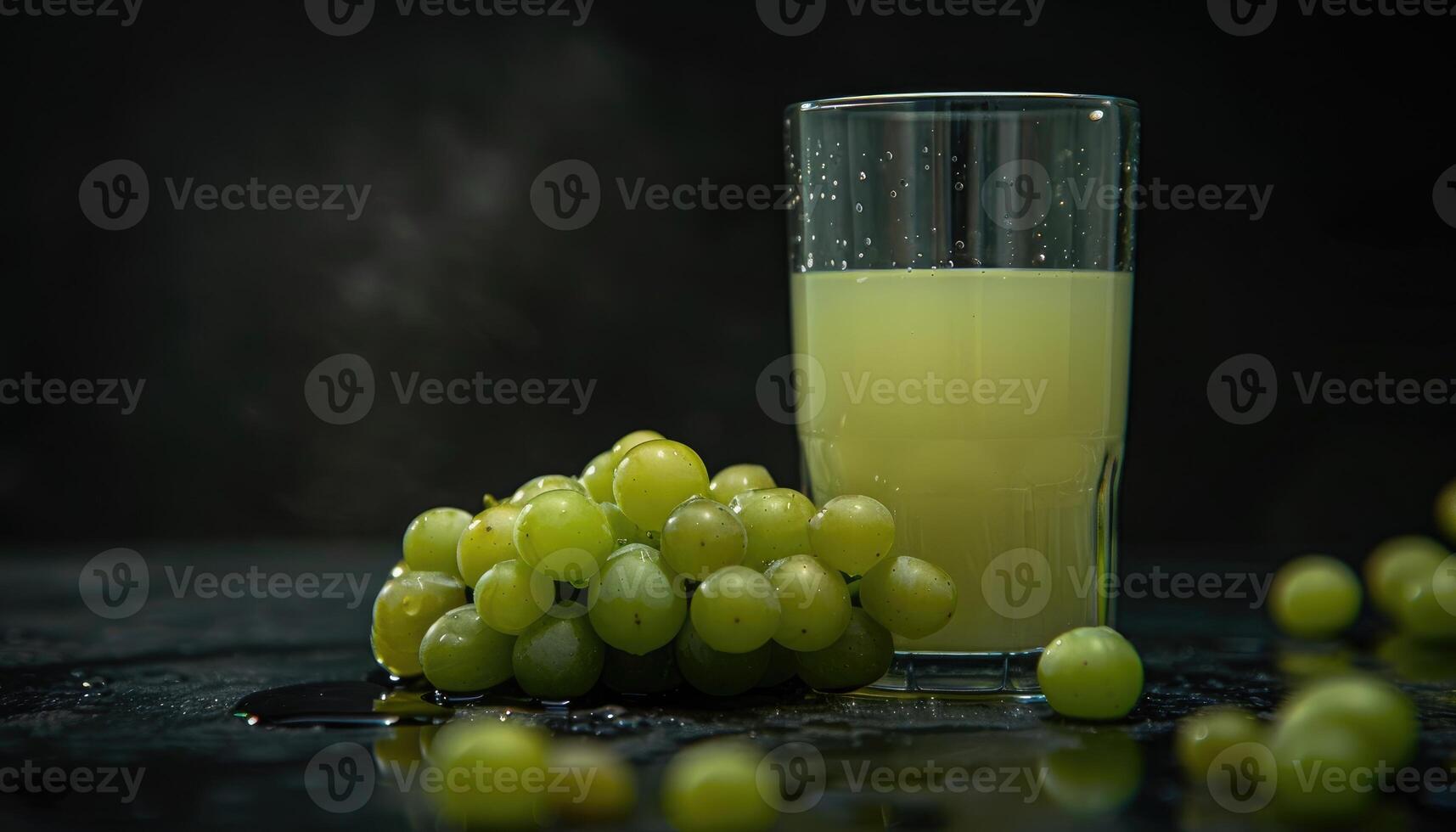 Green Grapes and a Glass of Juice on a Dark Background photo