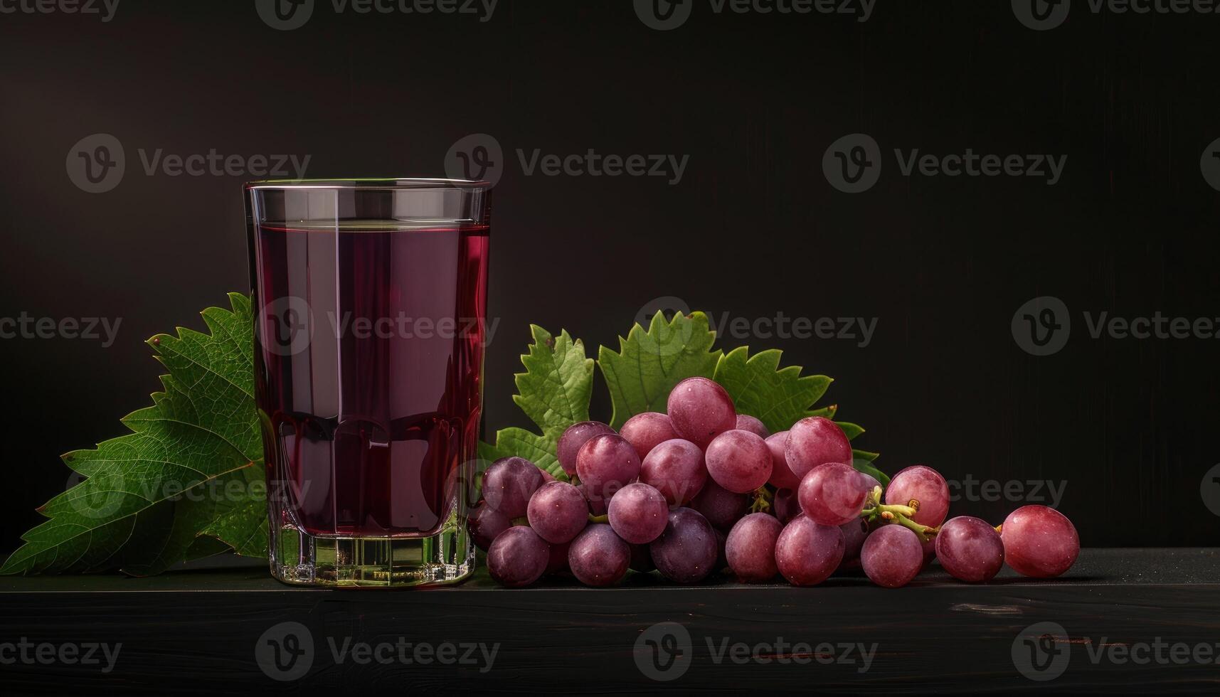 Glass of Grape Juice with Fresh Grapes and Green Leaves photo