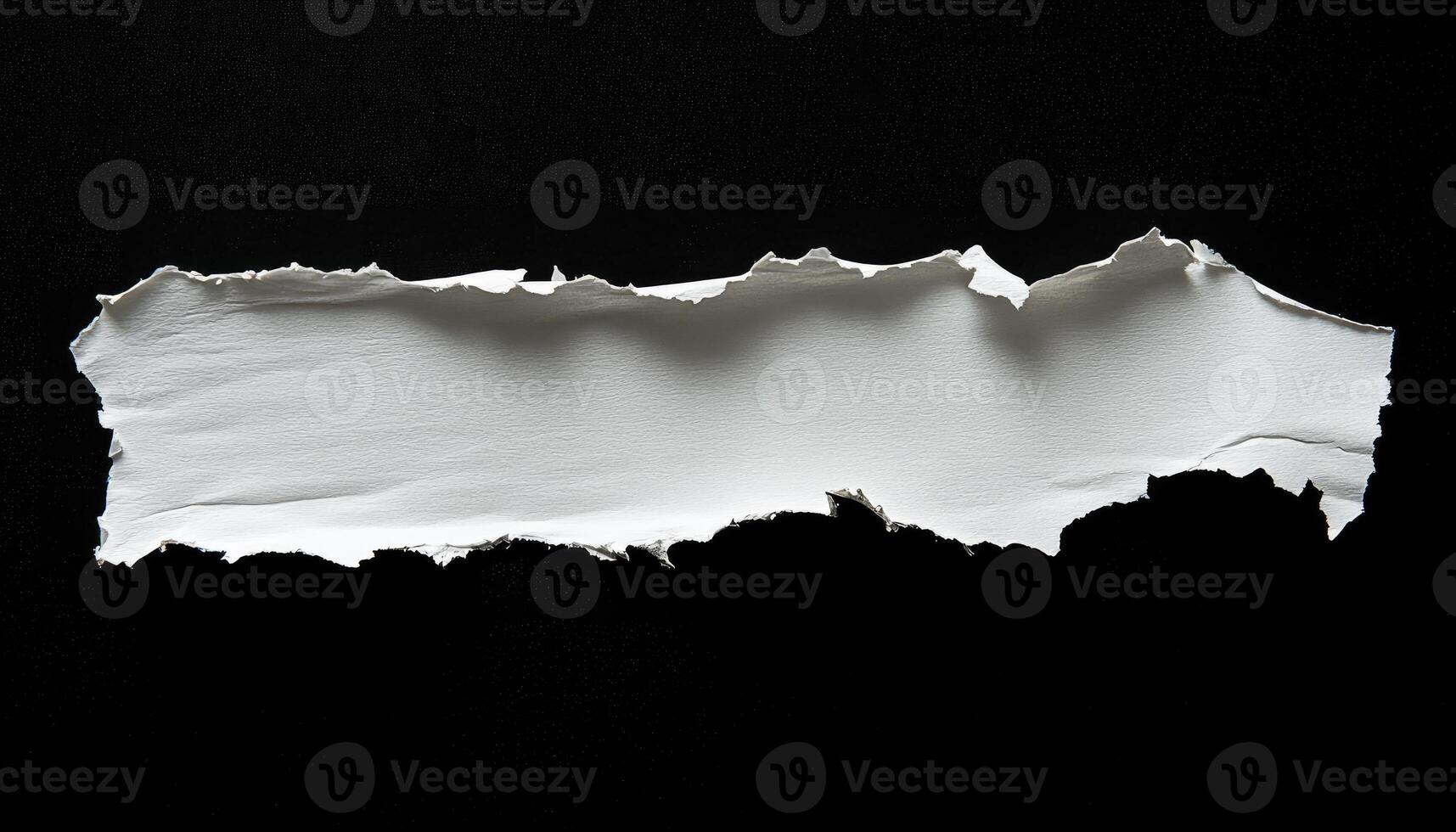 Torn White Paper with a Rough Edge Isolated on a Black Background photo