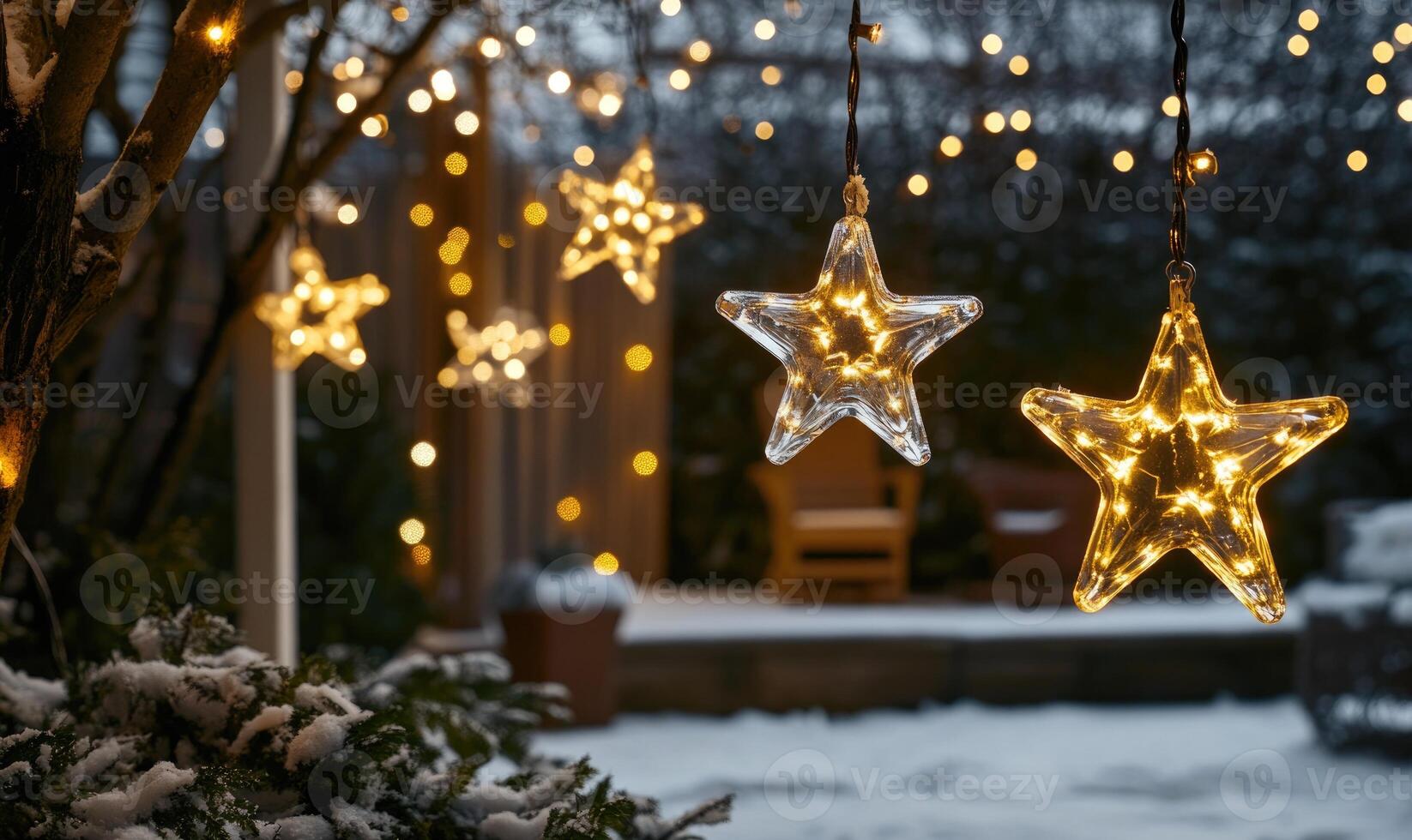A string of Christmas lights with stars hanging from a tree photo