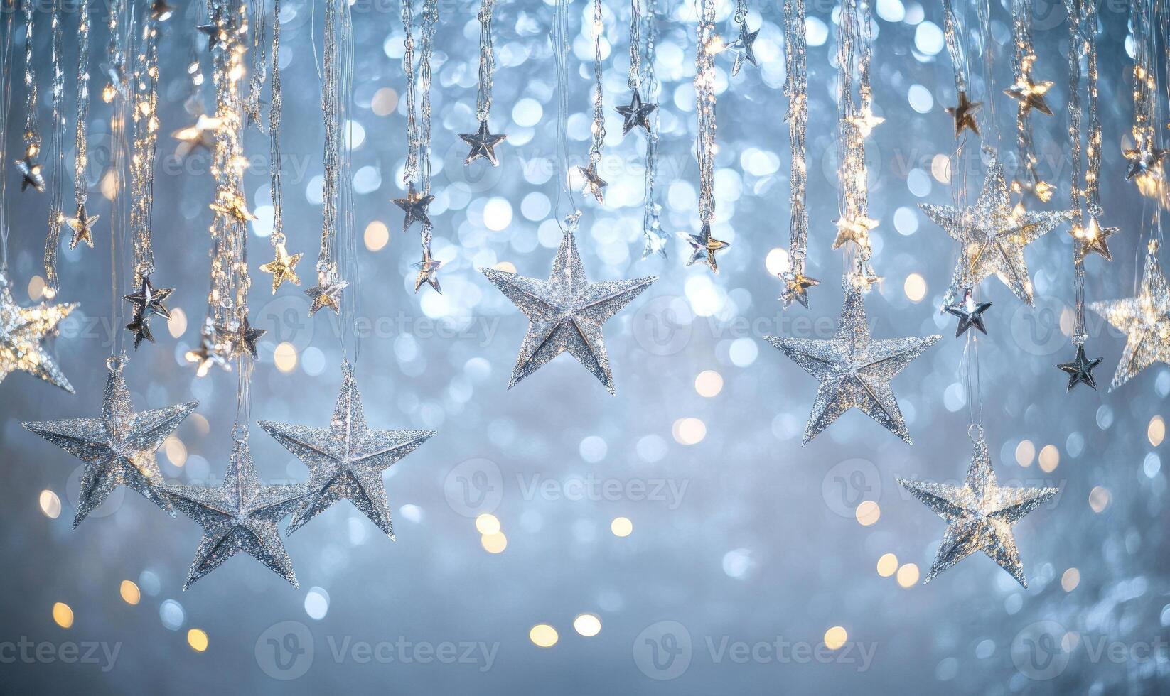 A blue background with a row of silver stars hanging from the ceiling photo
